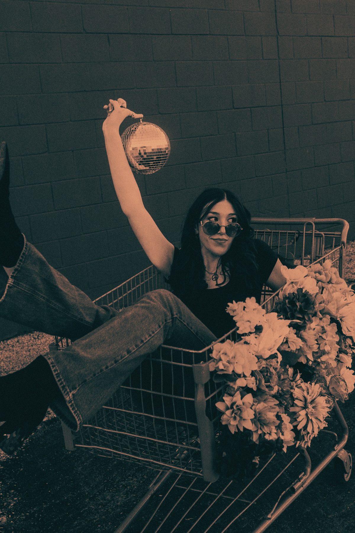 Brie Bamford sitting in a shopping cart full of flowers